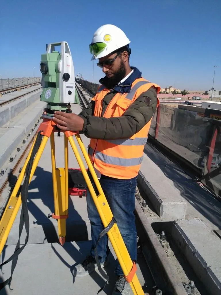Surveyor operating a total station on a Riyadh Metro viaduct